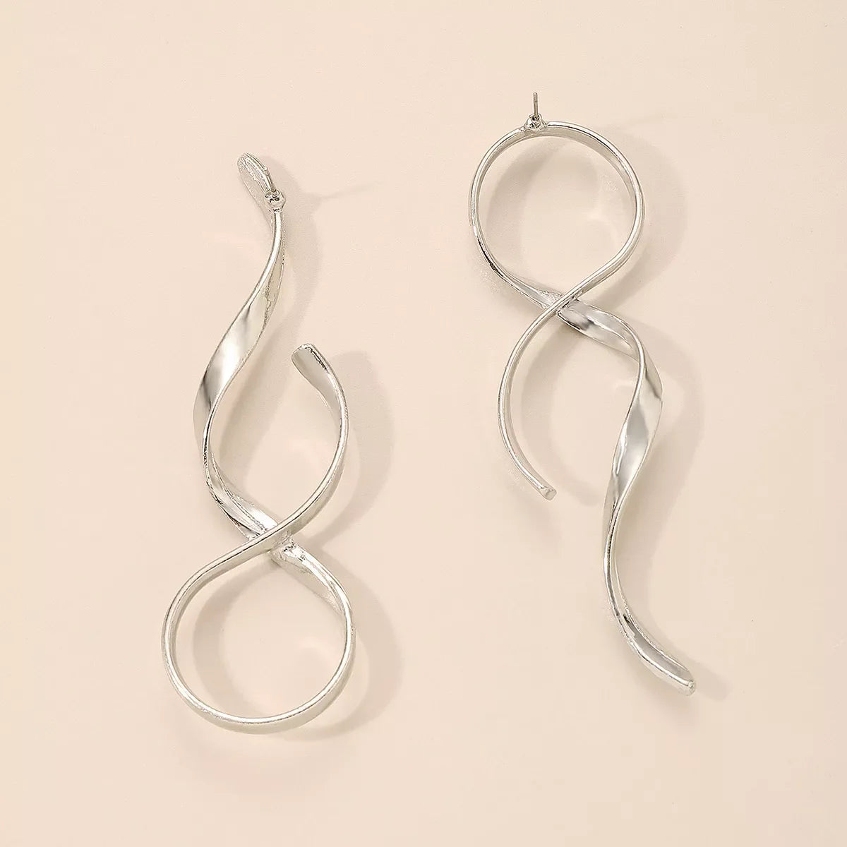 Silver alloy spiral drop earrings featuring a sleek, modern design, perfect for adding a stylish touch to any outfit.