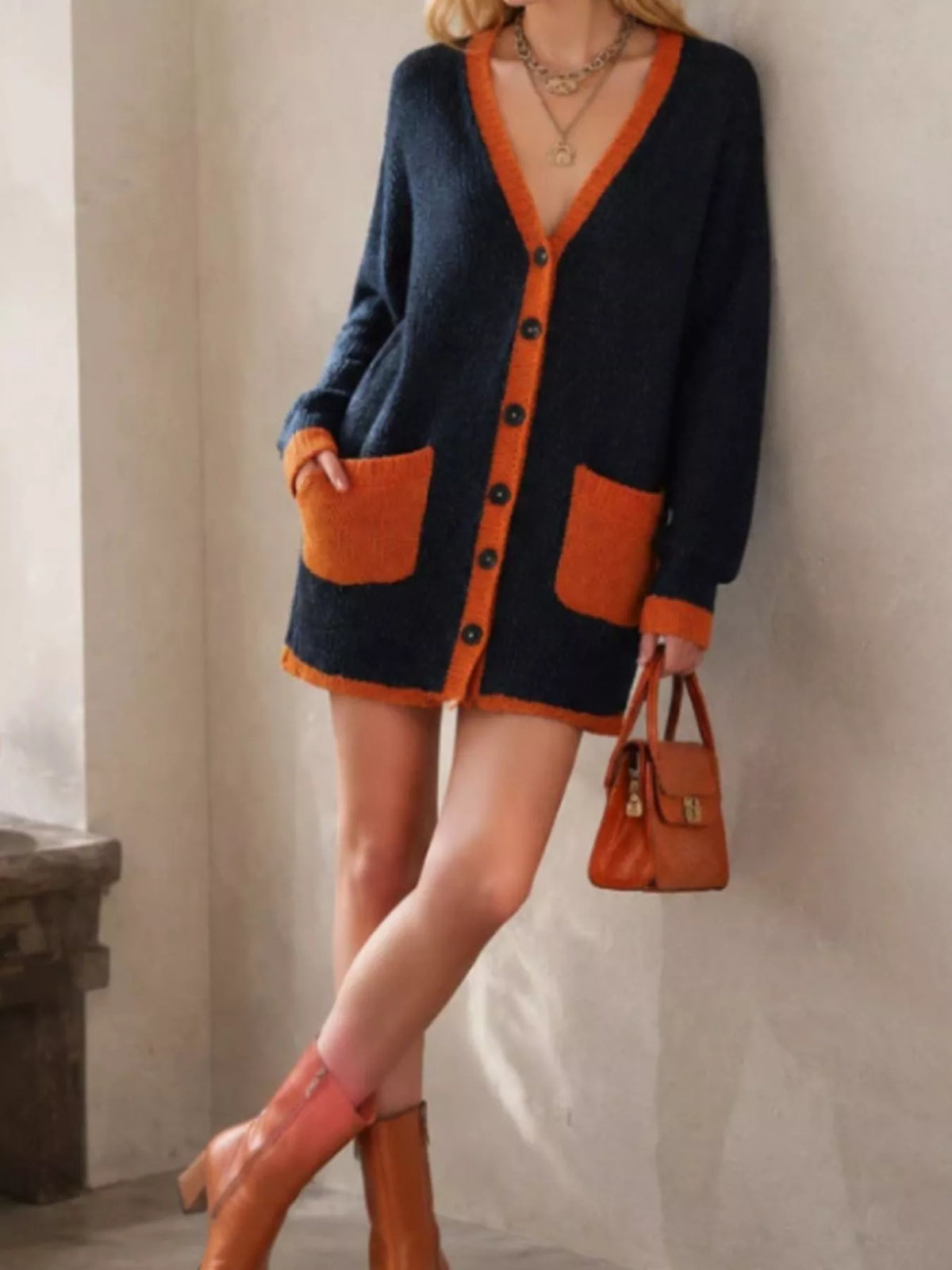 Color-block V-neck button-down knit cardigan by Trendsi, featuring vibrant color panels and a classic V-neck design.