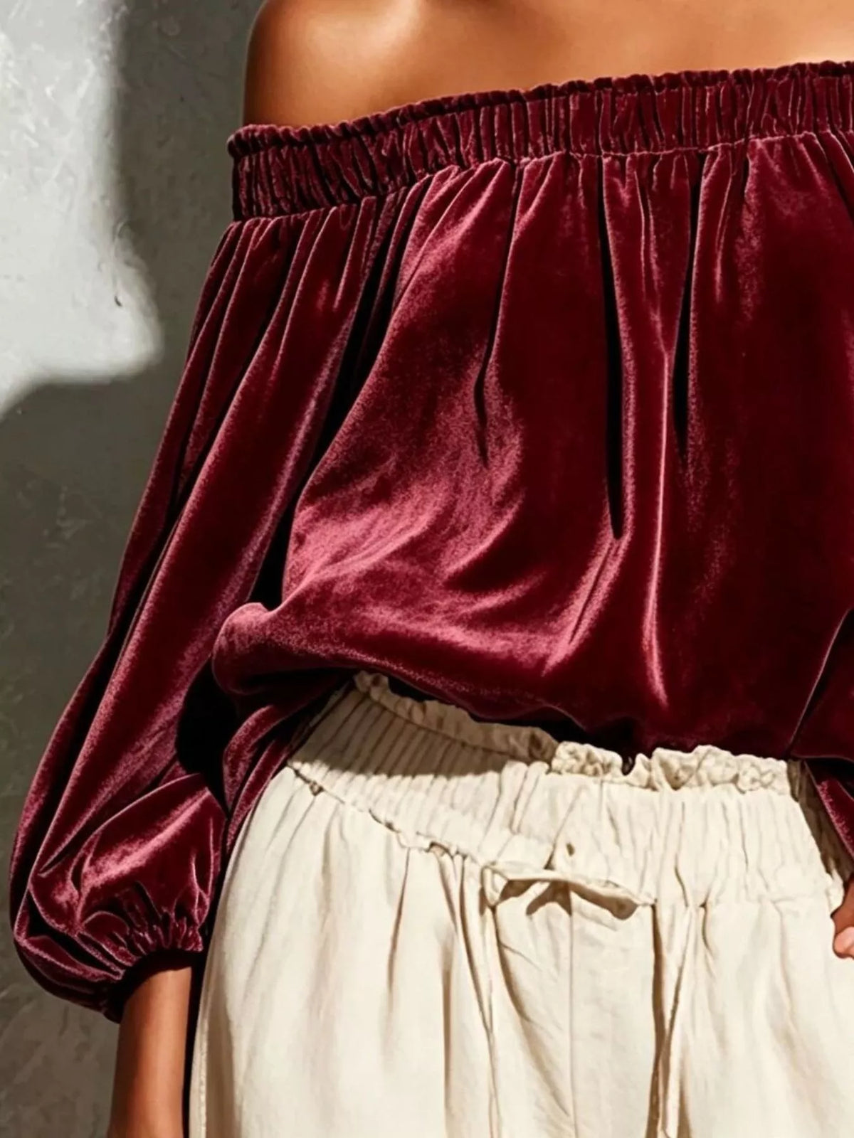 Off-shoulder velvet long sleeve T-shirt by Trendsi, featuring a stylish off-shoulder design and soft velvet fabric.