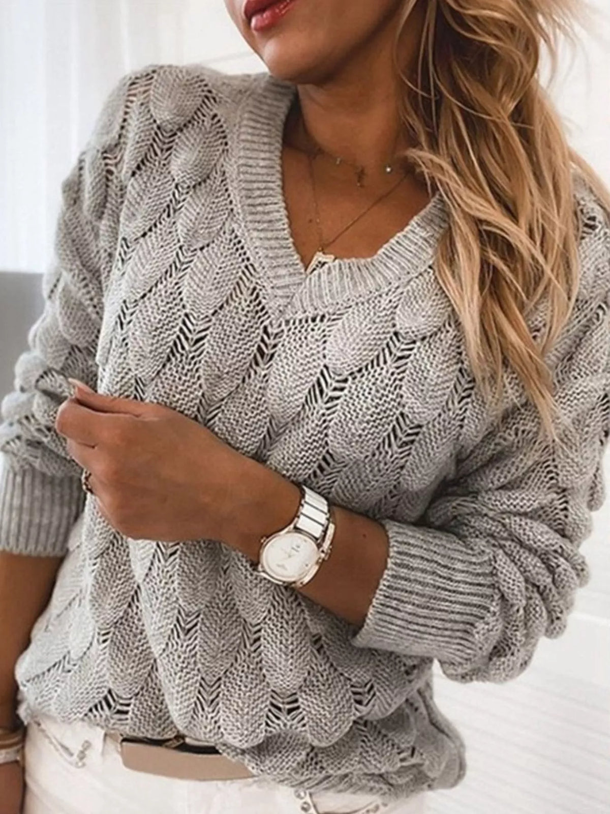 Trendsi V-neck knitted sweater in soft fabric, featuring a classic V-neckline and cozy knit pattern, suitable for casual wear.