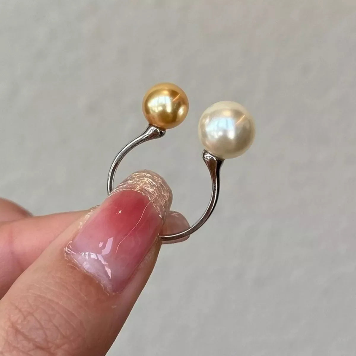 Plush Fashion Hub double pearl open ring showing a sleek silver band with two white pearls on each side of the open design