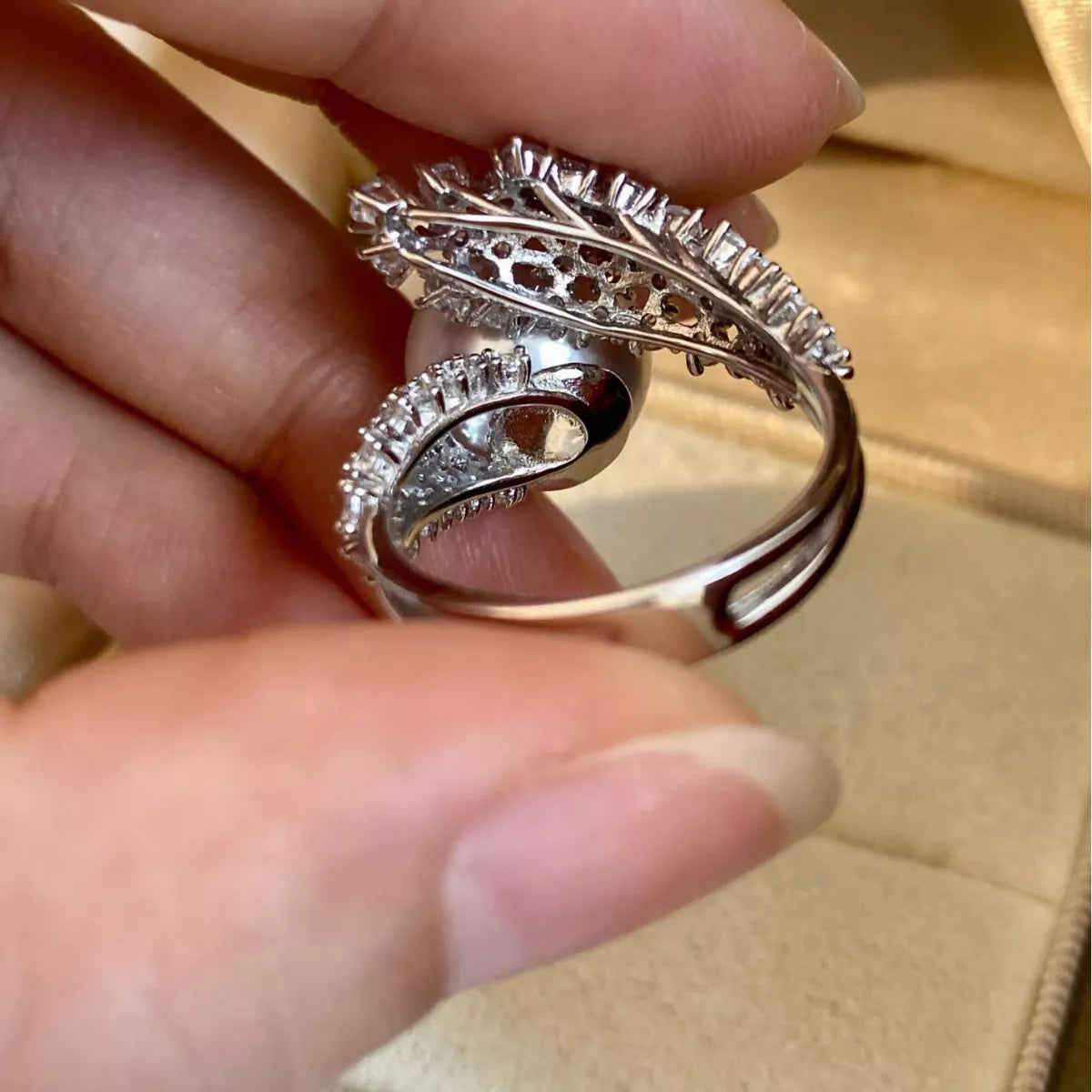 925 sterling silver pearl bypass ring with smooth, curved design featuring lustrous pearls and polished silver finish.