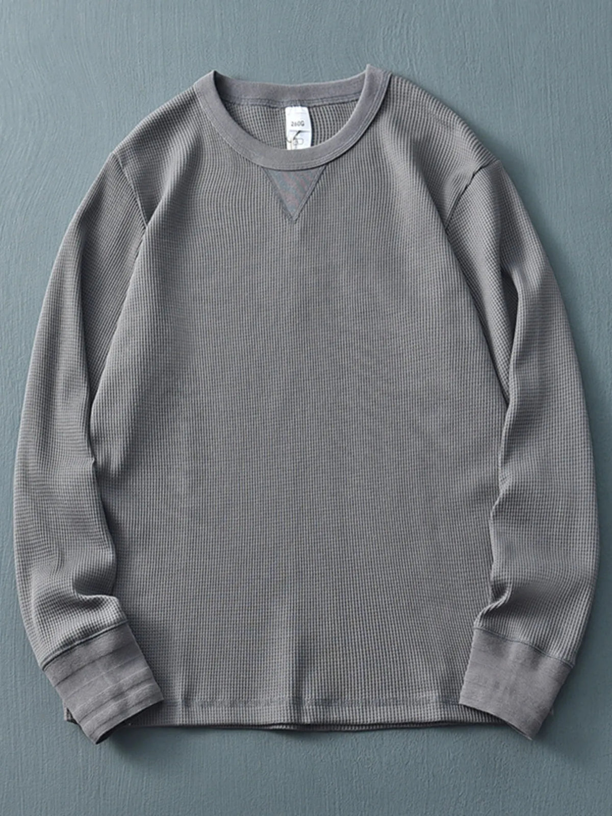 Plus size men's long sleeve round neck T-shirt by Trendsi, comfortable fit, in a solid color, shown on a mannequin.