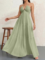 Backless halterneck V-neck pleated A-line dress from Plush Fashion Hub, showcasing elegant design and flowing fabric.