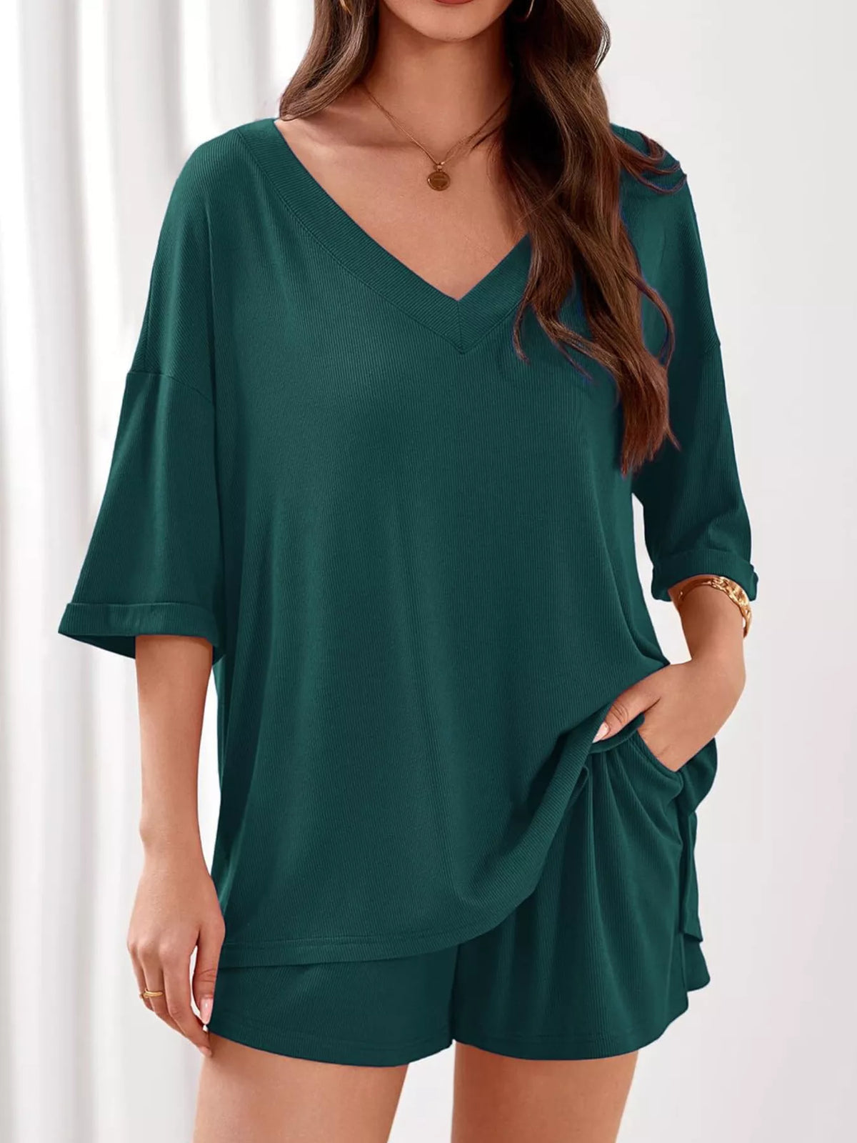 Women's casual V-neck top and shorts set by Plush Fashion Hub, solid color two-piece outfit for comfortable everyday wear.