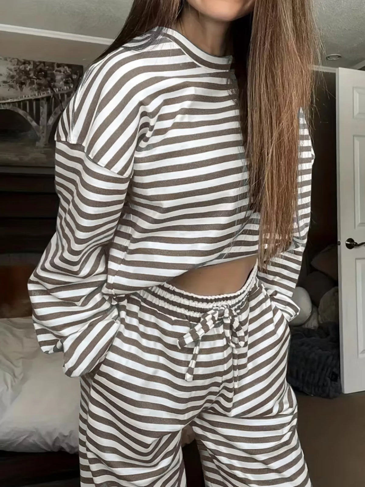 Striped dropped shoulder top and pants set by Trendsi featuring a relaxed fit and stylish casual design.