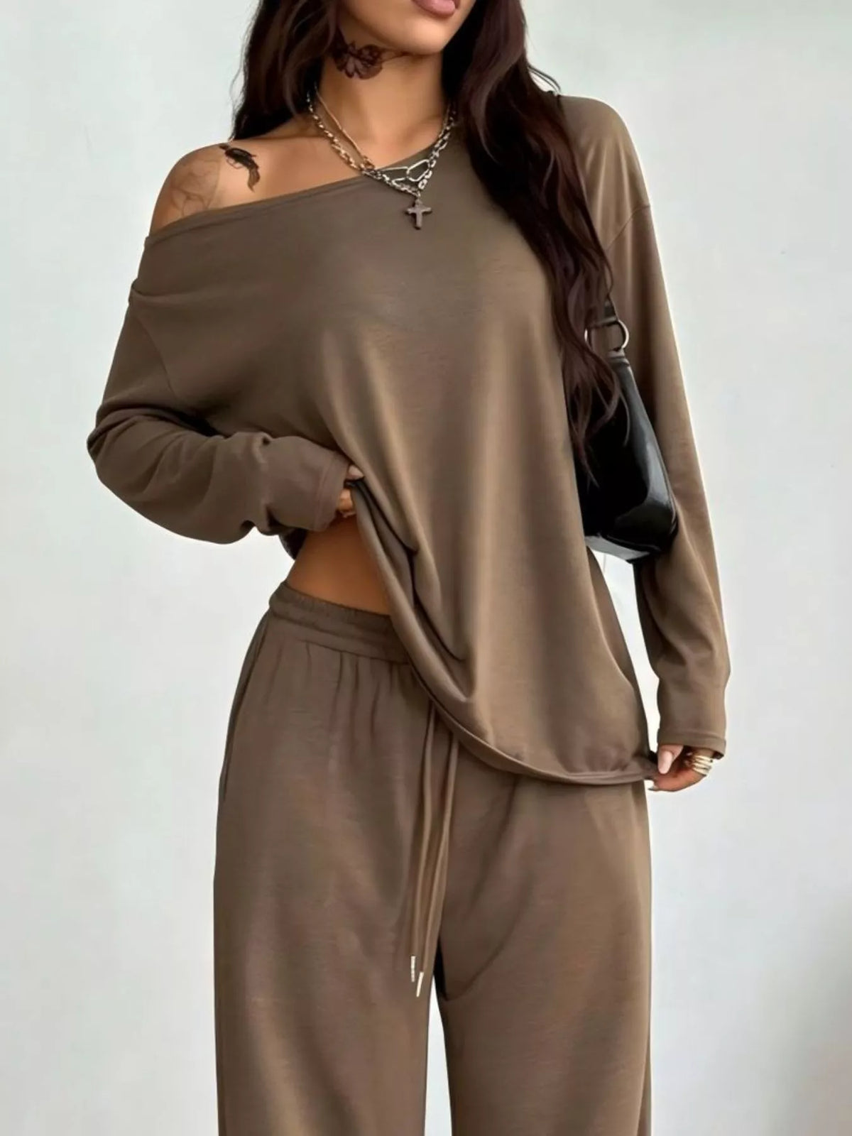 Plus size trendy one-shoulder top and drawstring pants matching set by Trendsi, casual and stylish full-size outfit.