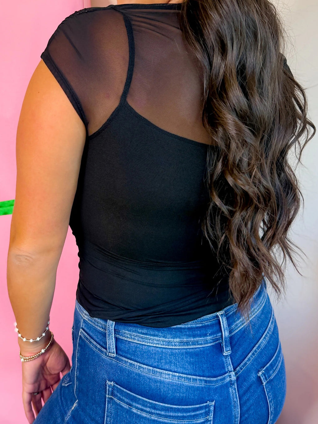 Women's sheer mesh patchwork cap sleeve T-shirt by Trendsi, featuring elegant layering design and stylish rings detail.