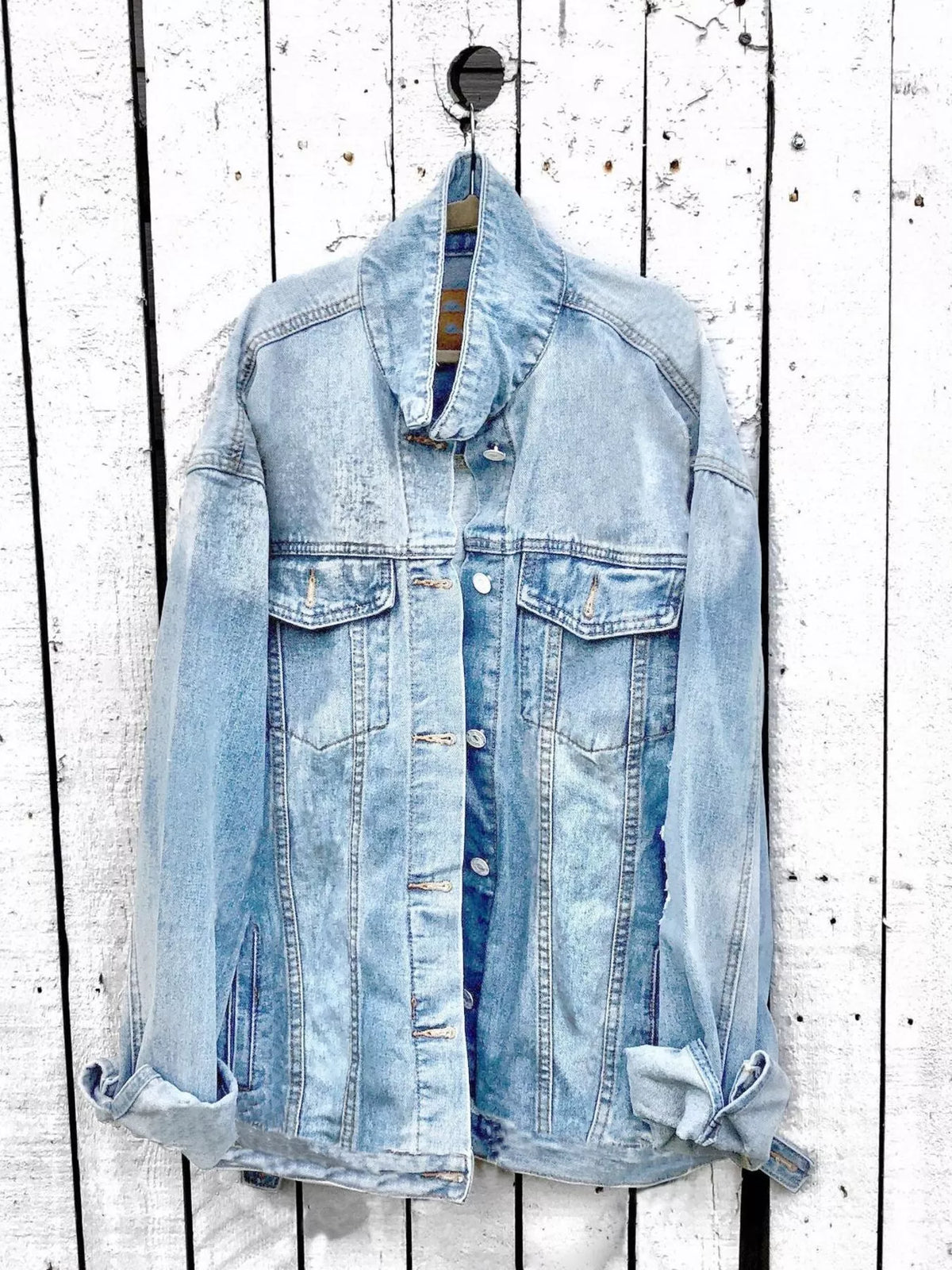 Plus size denim jacket with angel wings graphic back design, trendy fashion piece from Trendsi.