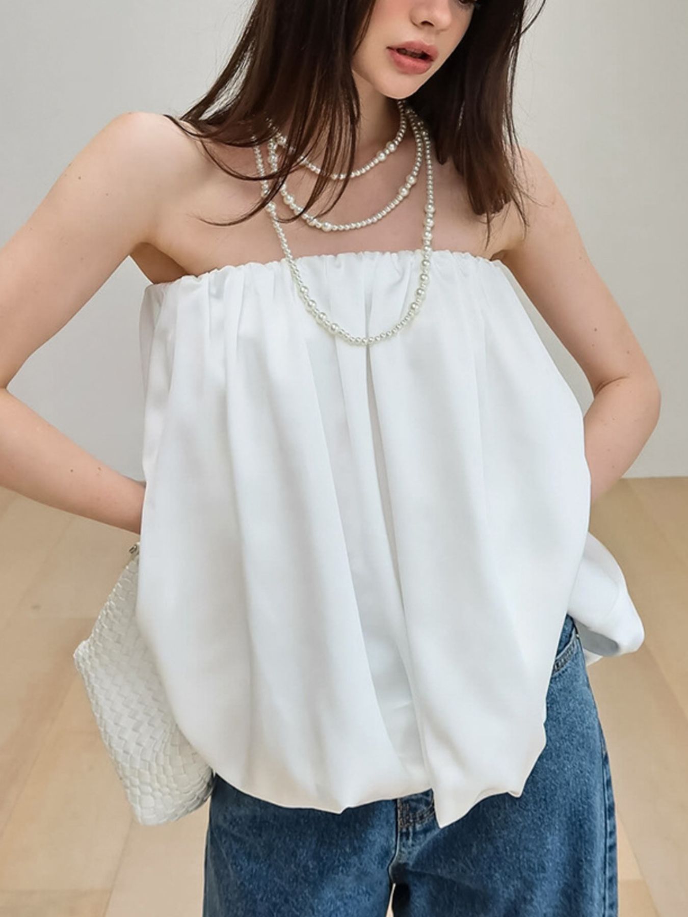 Women's strapless bubble hem tube top from Trendsi, featuring a sleek minimalist design and trendy crop top style.
