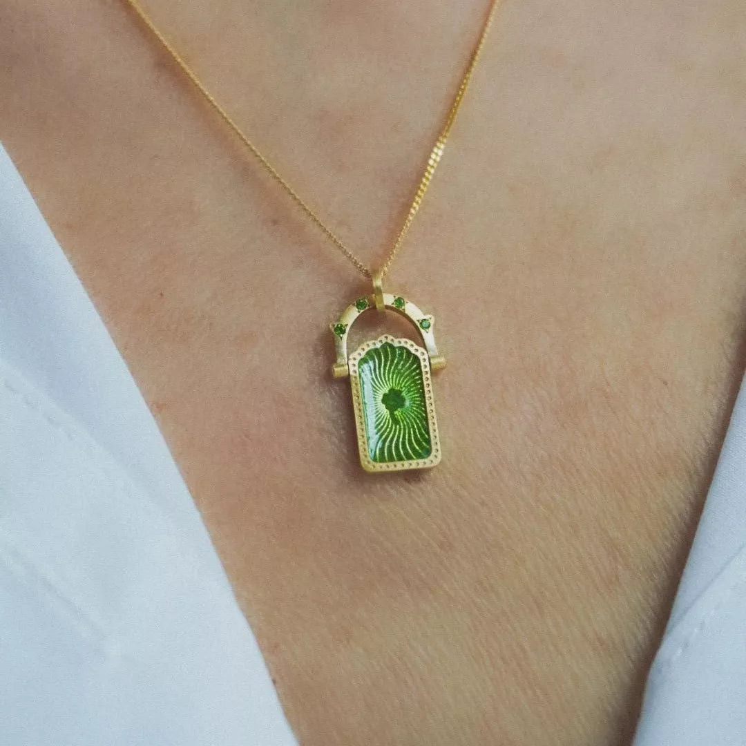 18K gold-plated titanium steel pendant necklace with a sleek, modern design, showcasing a polished, reflective surface.