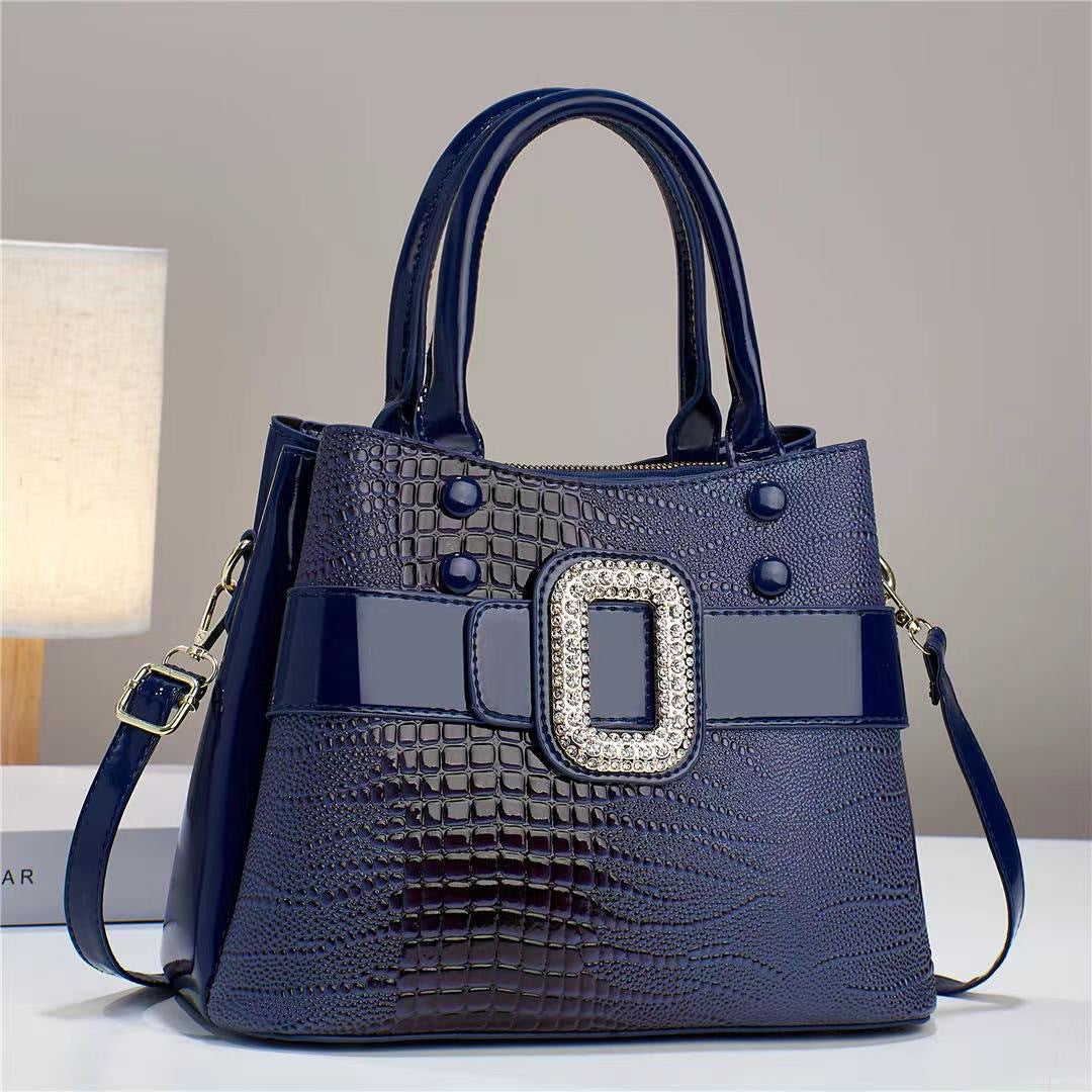 Lizard patterned mini bucket crossbody bag with zipper from Plush Fashion Hub, featuring a stylish design and compact size.