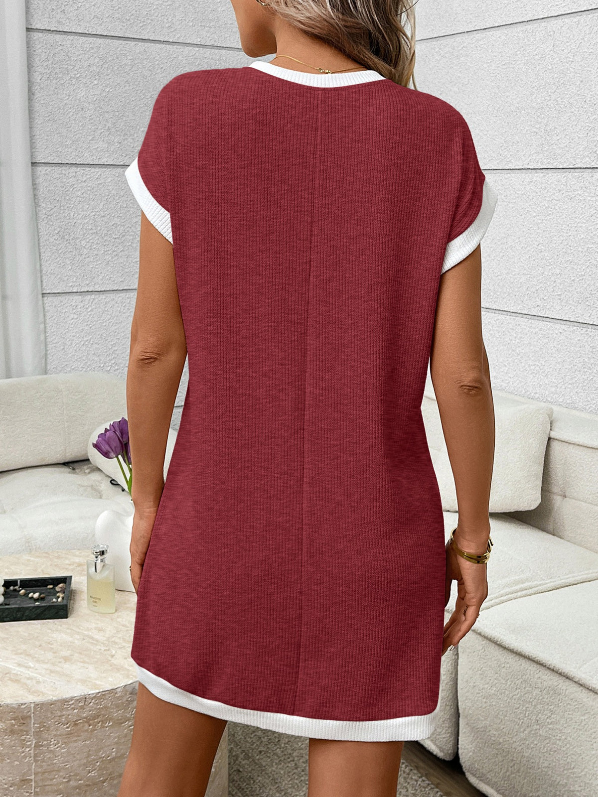 Ribbed knit mini dress with contrast trim and functional pocket from Plush Fashion Hub, featuring a fitted silhouette and short sleeves.