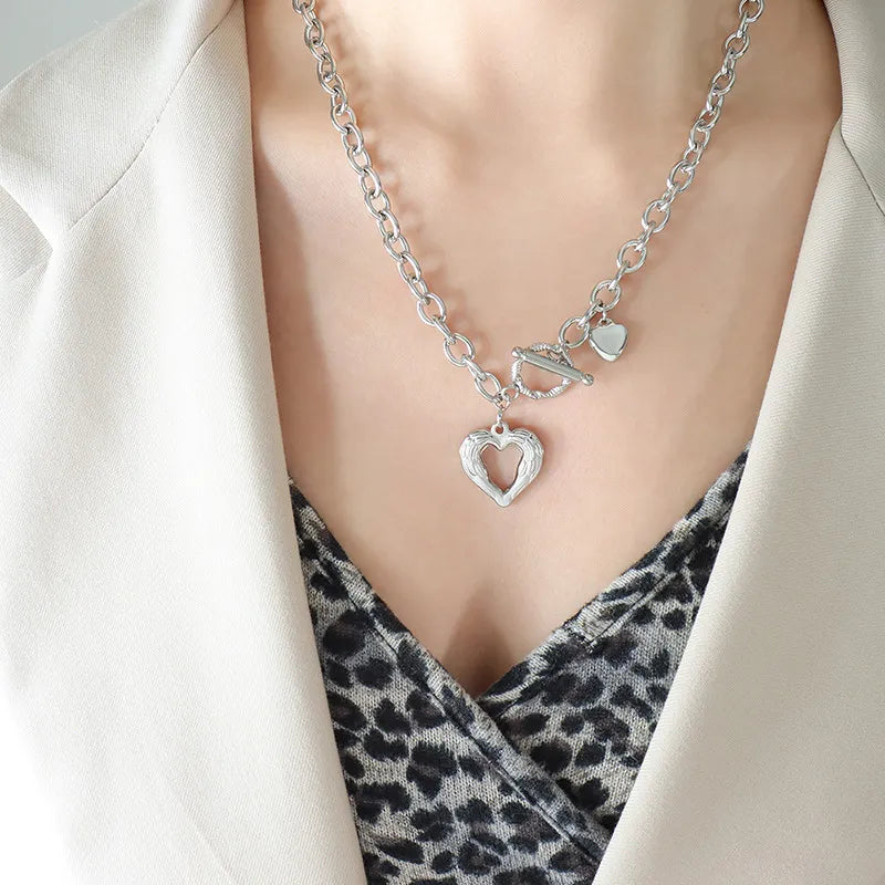 Titanium steel heart pendant necklace with a sleek design, featuring a polished finish and a secure chain closure.