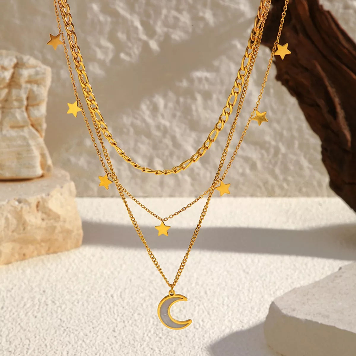 18K gold-plated three-layer moon necklace featuring delicate crescent and full moon charms on a layered chain.