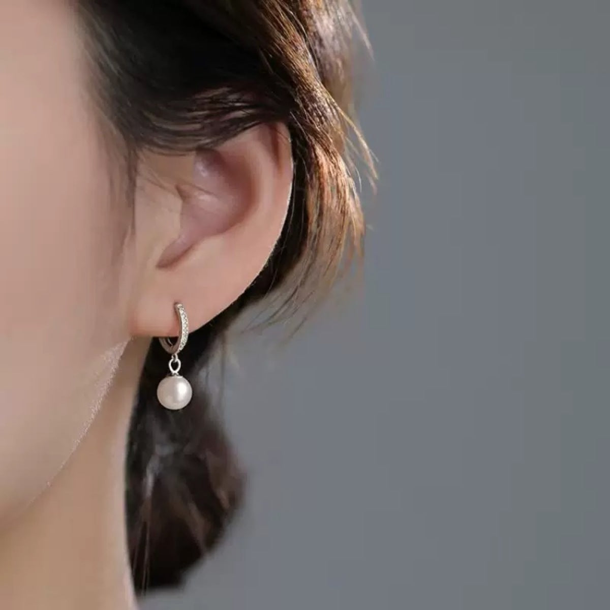 Pearl drop hoop earrings by Plush Fashion Hub featuring elegant pearls hanging from gold-toned hoops.