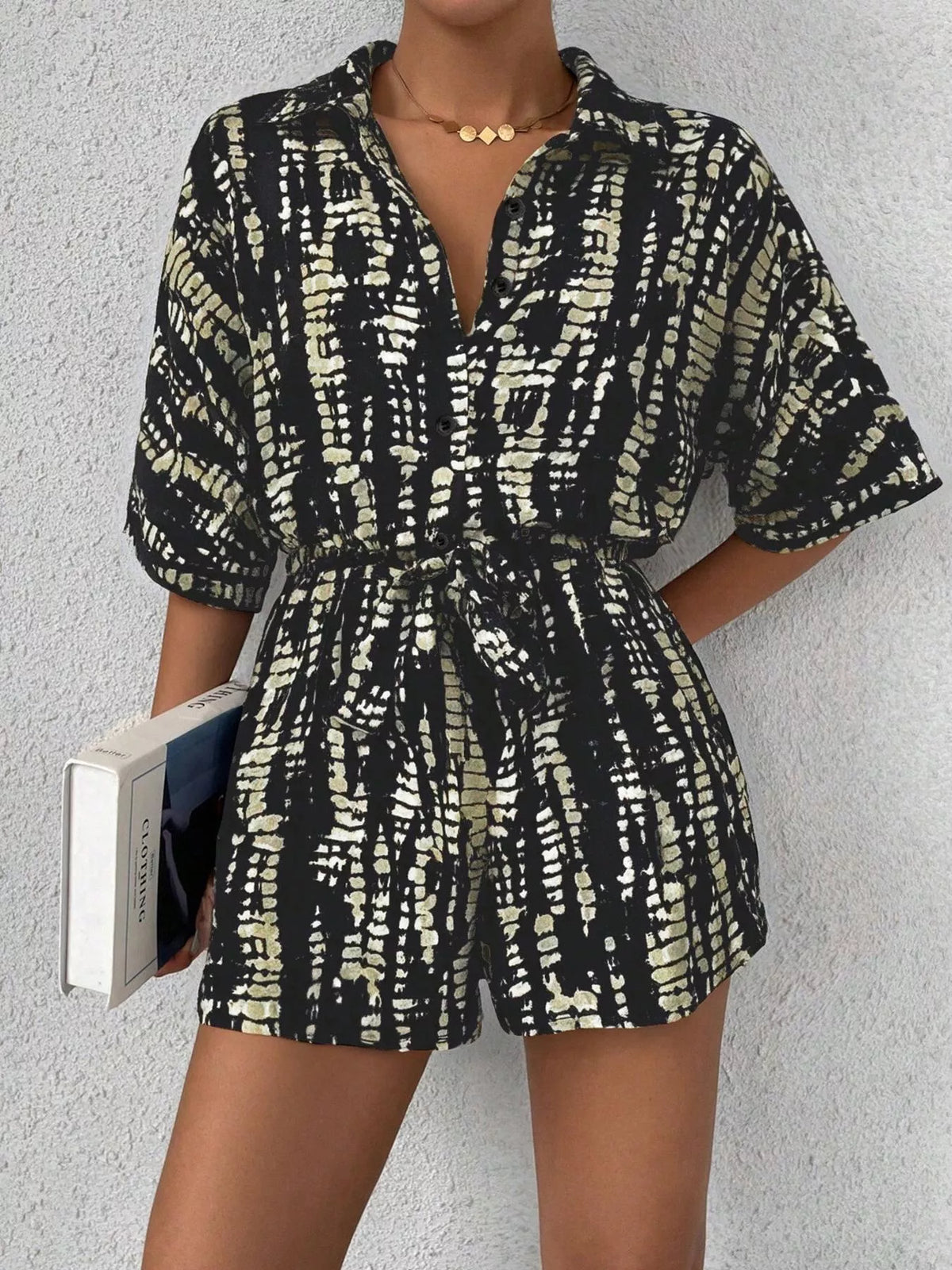 Striped button-up belted romper jumpsuit by Plush Fashion Hub, featuring a stylish design and tied waist detail.