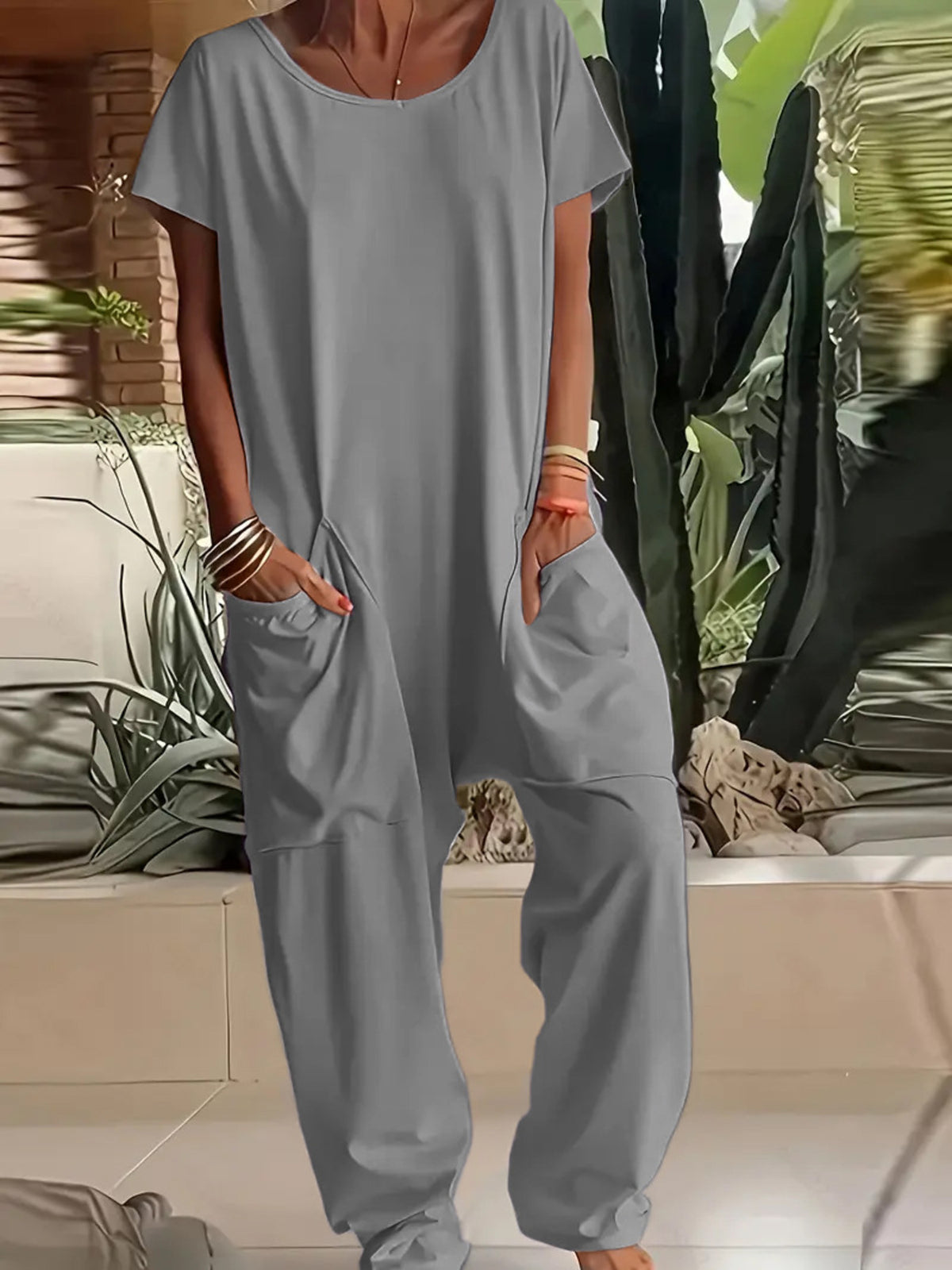 Plus size loose fit V-neck short sleeve jumpsuit with wide-leg pants by Trendsi, shown on a model.