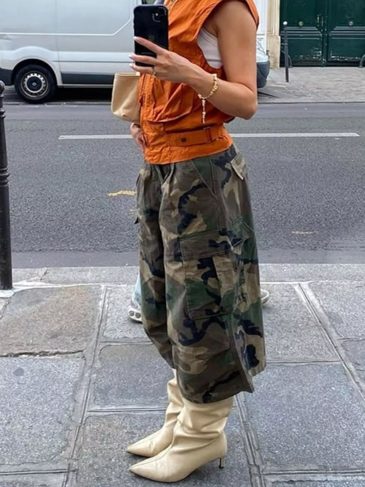 Camouflage cargo cropped pants by Plush Fashion Hub featuring multiple pockets and a relaxed fit in a green and brown camo pattern.