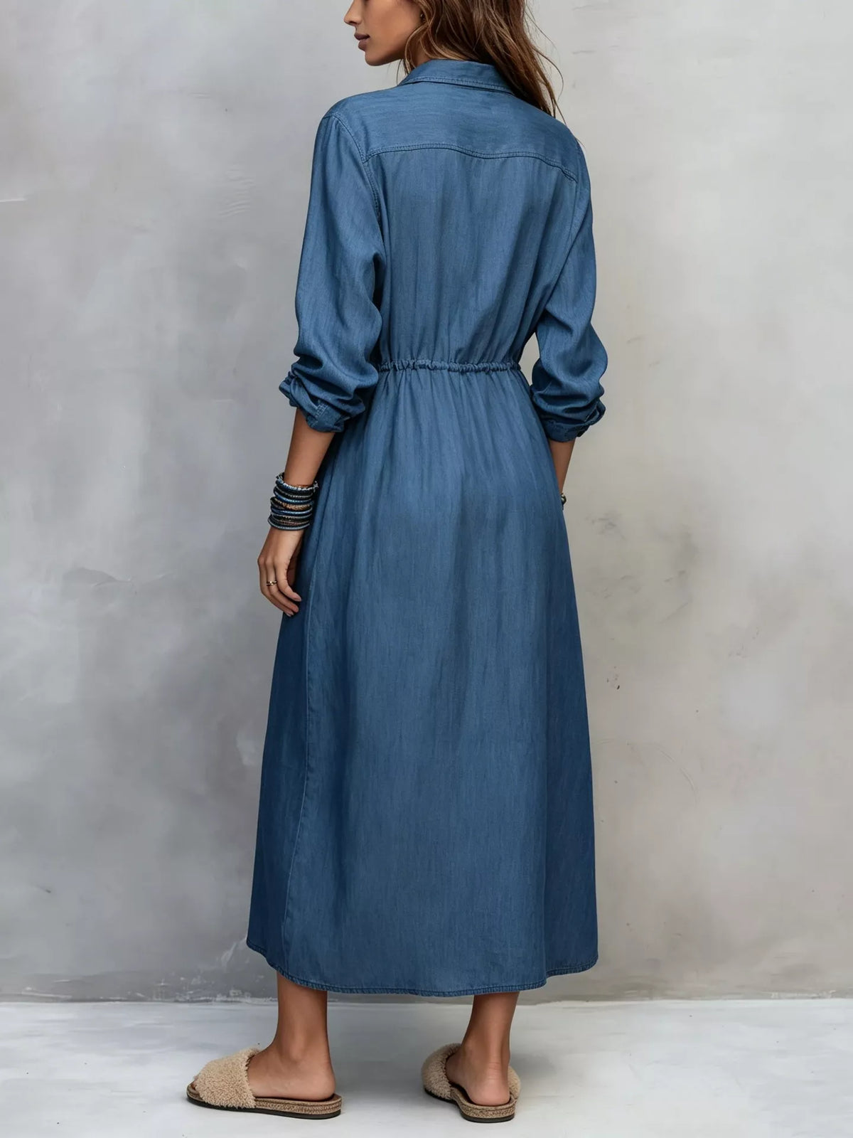 Plus size long sleeve button-front shirt dress by Trendsi, shown in a stylish, comfortable dress with a classic collar and front buttons.