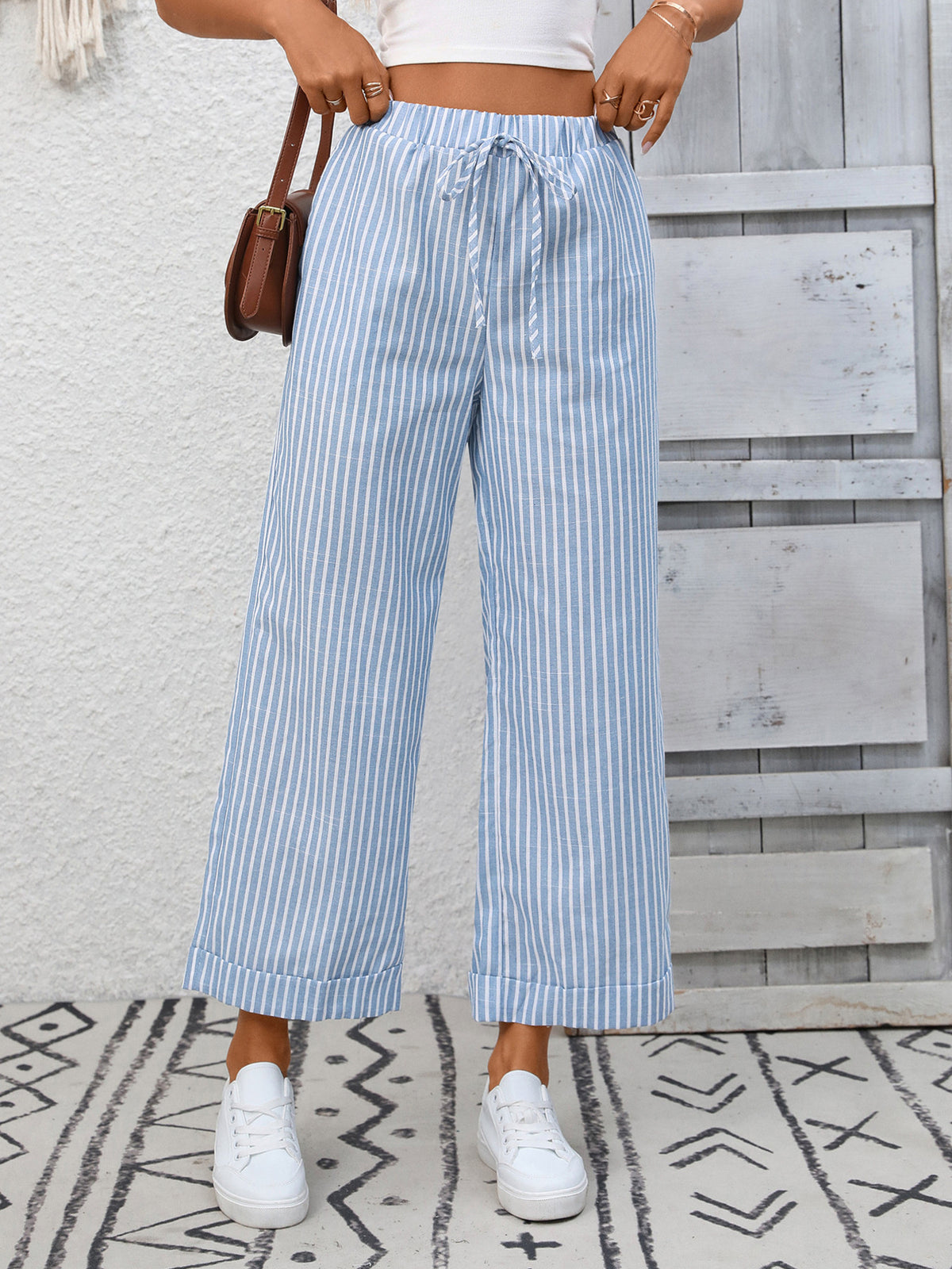Women’s striped wide-leg drawstring pants with pockets by Plush Fashion Hub, featuring a relaxed fit and stylish design.