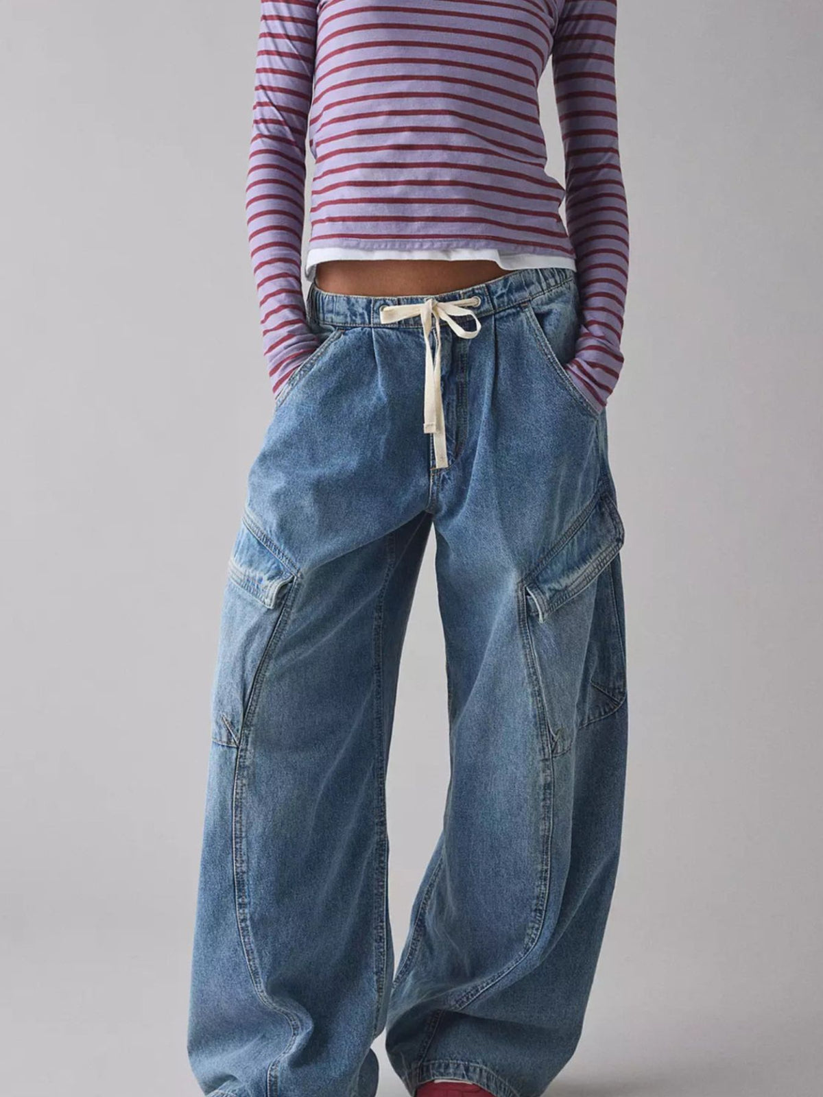 Women's relaxed fit denim cargo jeans with drawstring waist by Plush Fashion Hub, featuring multiple utility pockets.