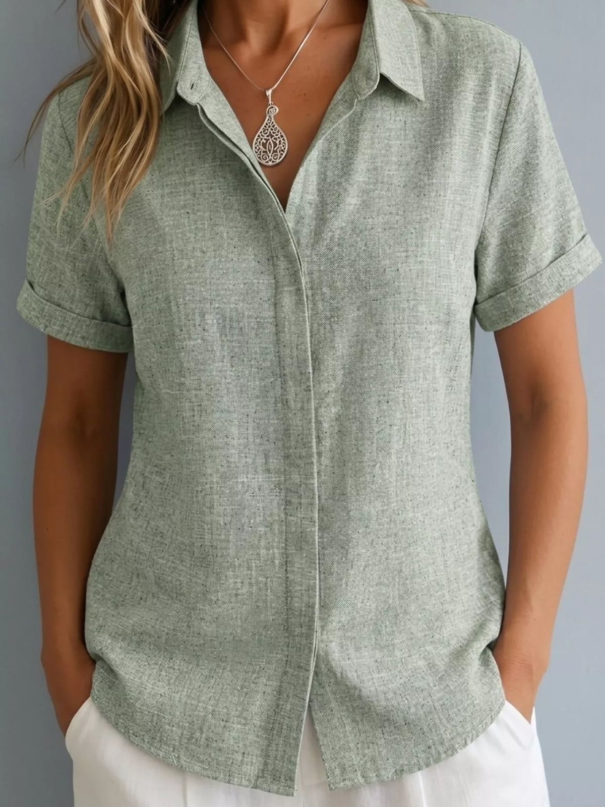 Plus size collared short sleeve shirt by Trendsi, shown in full view, featuring a classic collar and relaxed fit for casual wear.
