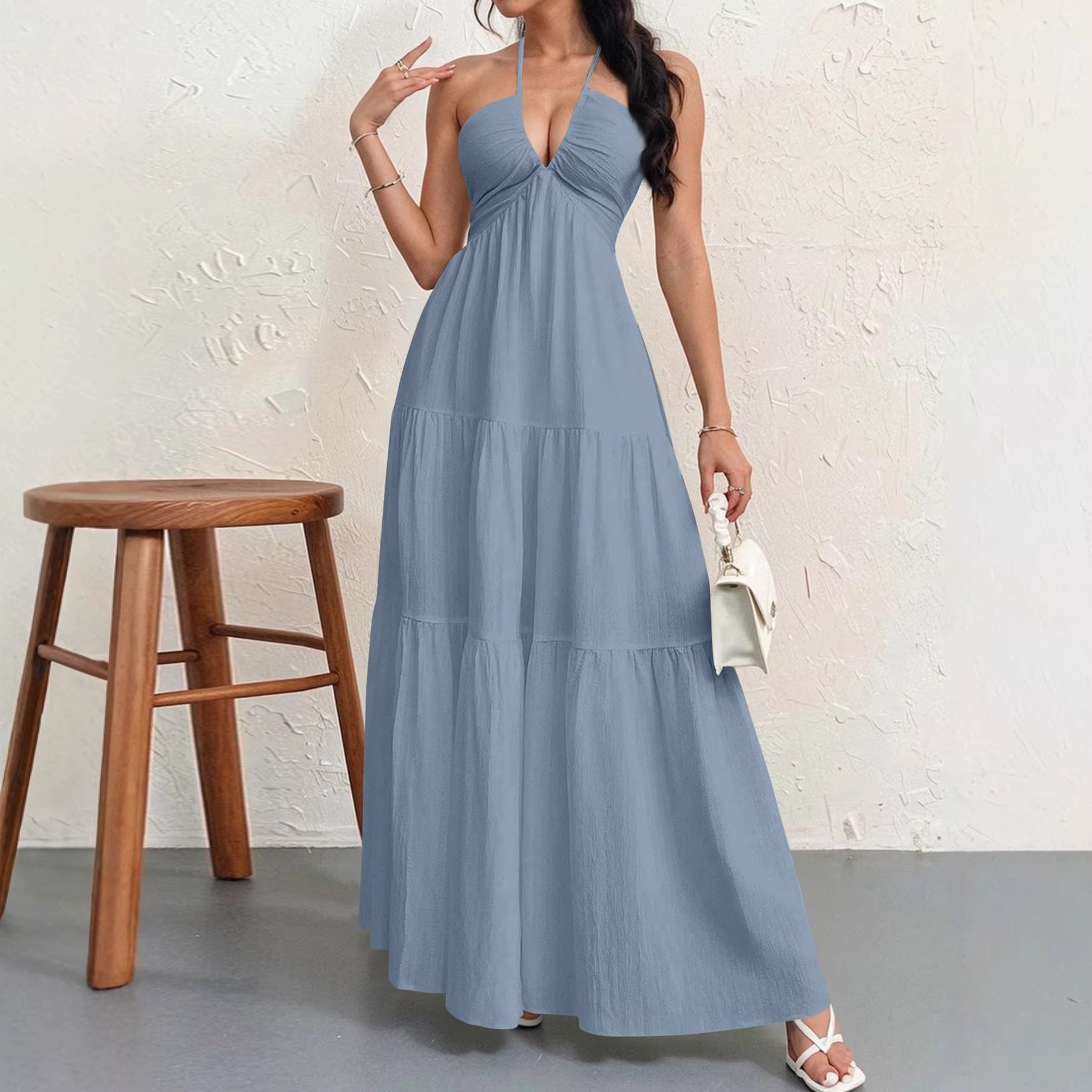 Backless halterneck V-neck pleated A-line dress for women by Plush Fashion Hub, shown with flowing fabric and elegant design.