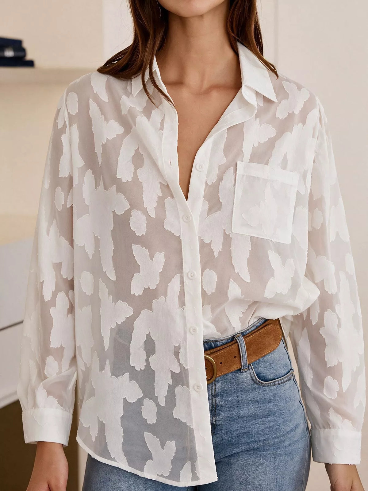 Sheer button-down shirt by Trendsi featuring lightweight, transparent fabric and classic collar, displayed on a hanger.