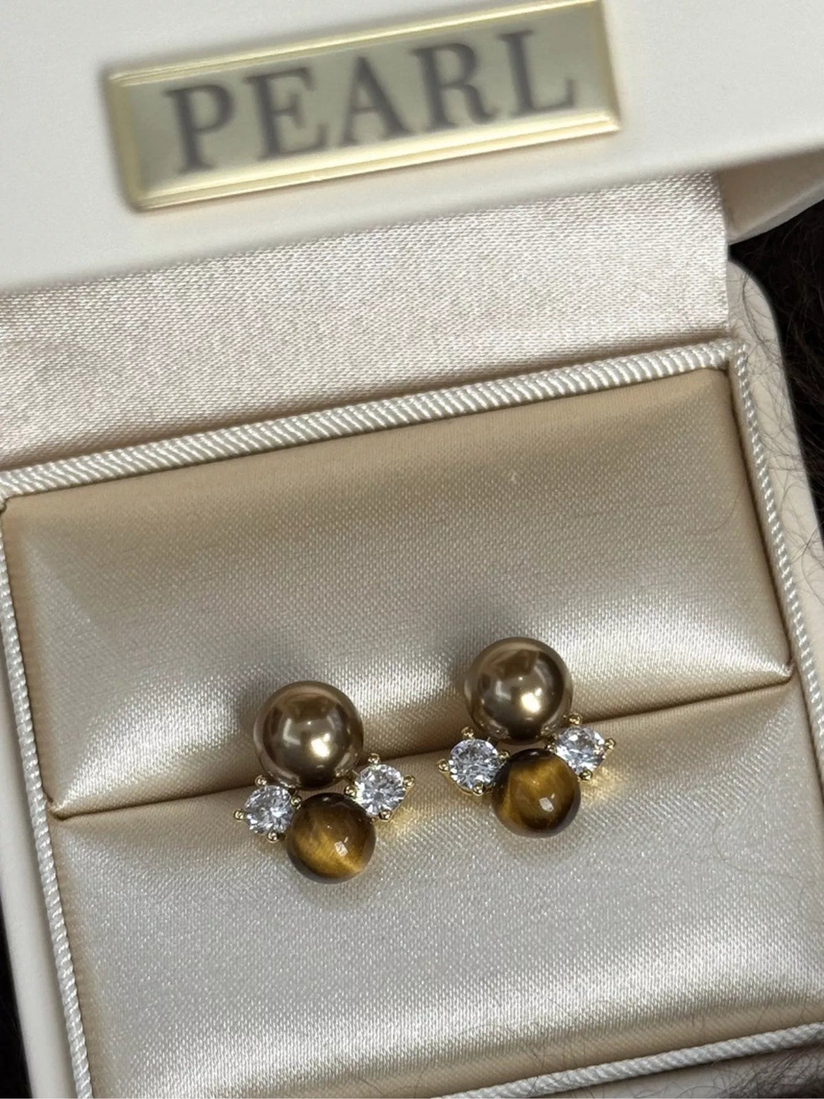 Tiger Eye stud earrings by Plush Fashion Hub featuring polished, golden-brown gemstone studs on a silver setting.