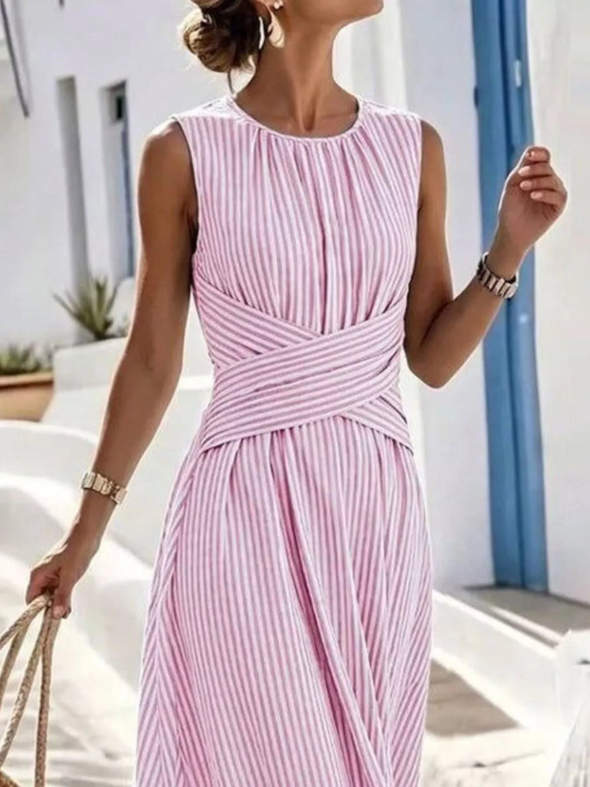 Plus size striped sleeveless maxi dress by Trendsi, featuring a colorful striped pattern and a flowing full-length design.