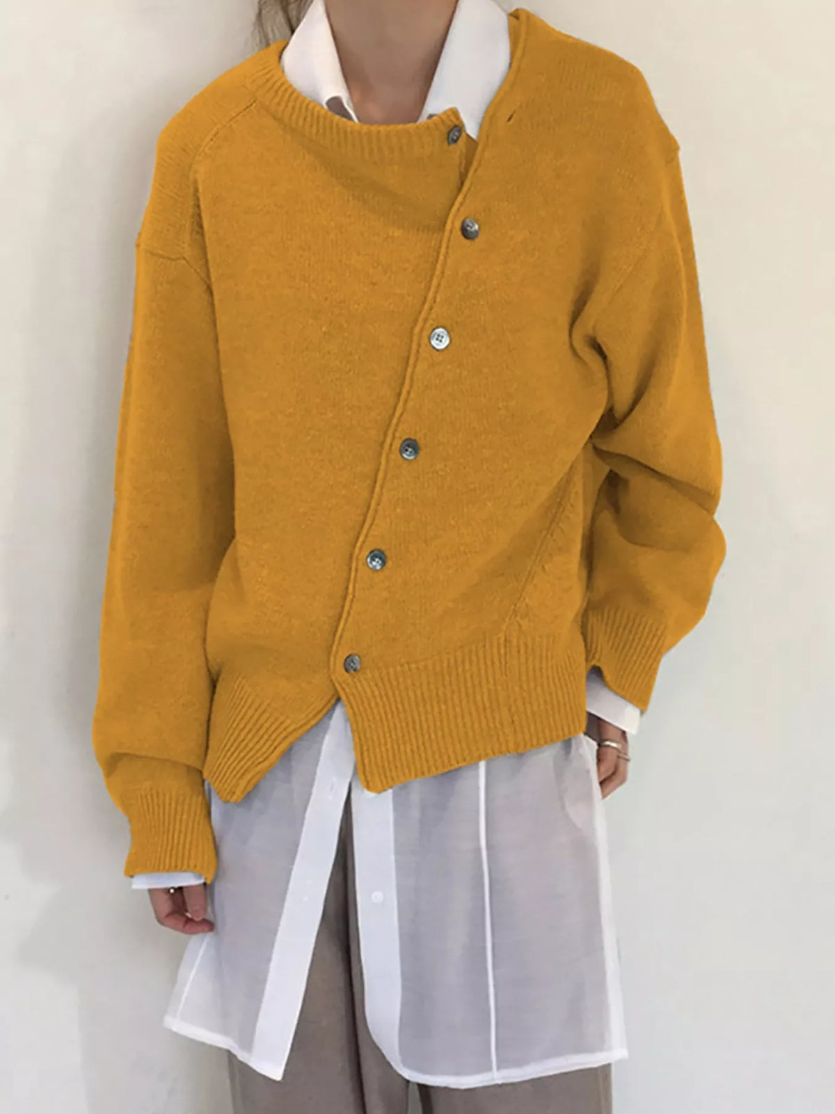 Asymmetric button-down sweater by Trendsi, featuring a stylish design with unique button details and a cozy knit fabric.