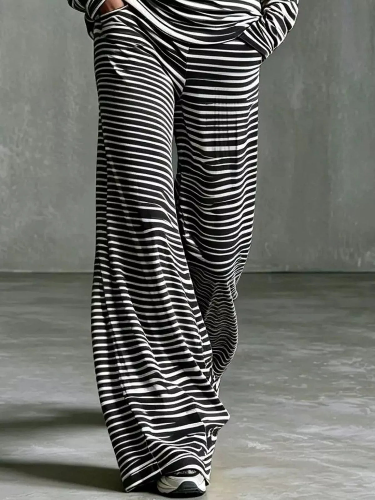 Women's striped boat neck top and matching pants set by Trendsi, featuring a casual, stylish design with vertical stripe pattern.