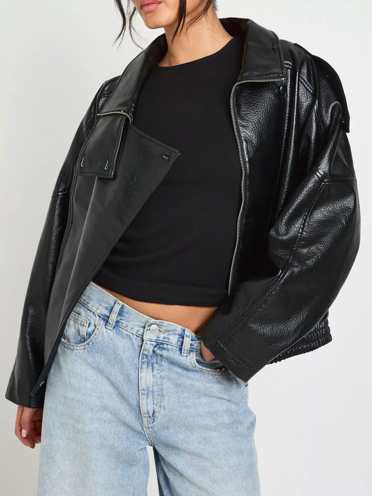 Women's faux leather moto jacket with asymmetrical zip, black trendy jacket from Trendsi featuring stylish design and fitted silhouette.