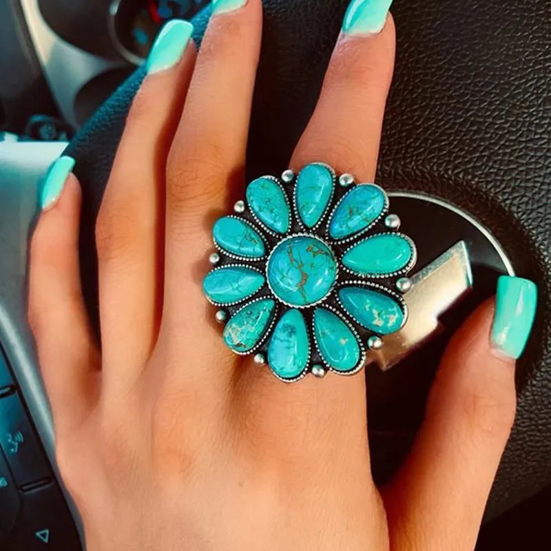 Artificial turquoise alloy flower ring showing a detailed flower design on a silver-tone band.