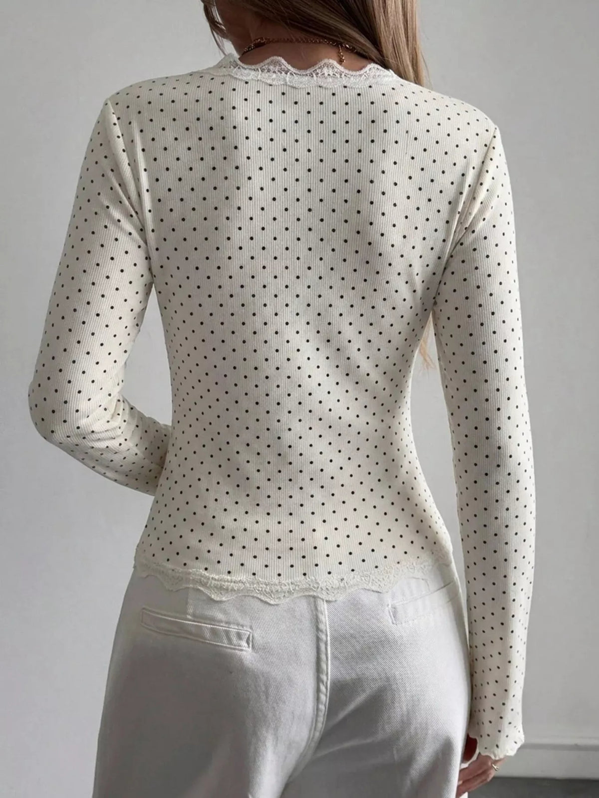 Ribbed long sleeve blouse with lace trim and V-neck, stylish women's top from Trendsi featuring textured fabric and elegant design.