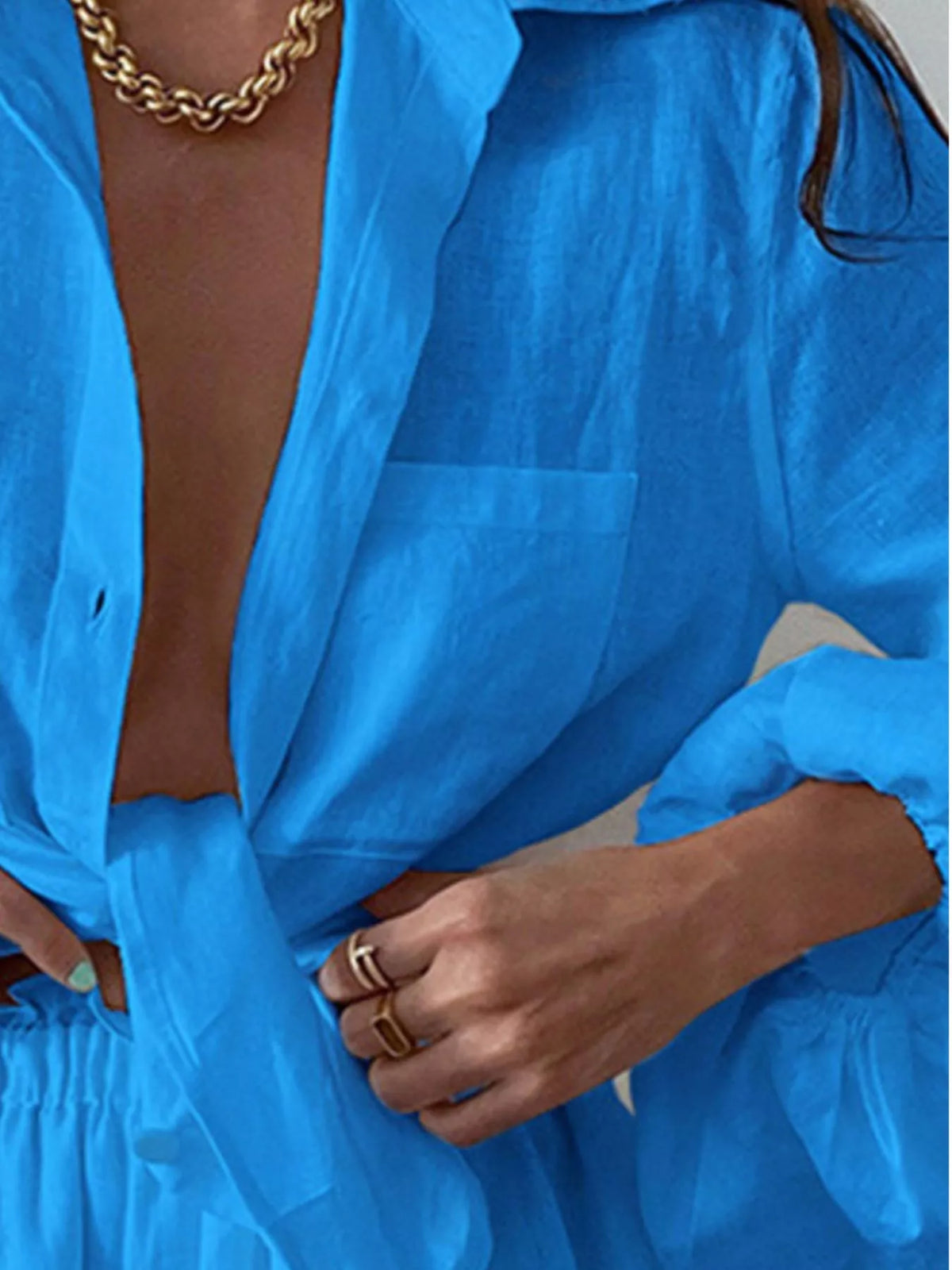 Plush Fashion Hub two-piece set featuring a button-up long sleeve shirt and matching shorts in soft fabric.