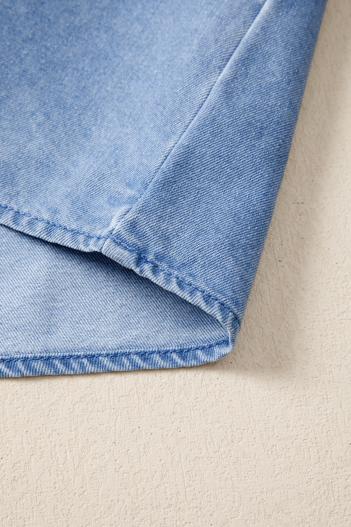 Women's distressed denim top with frilled collar and flutter sleeves, stylish casual top from Plush Fashion Hub.