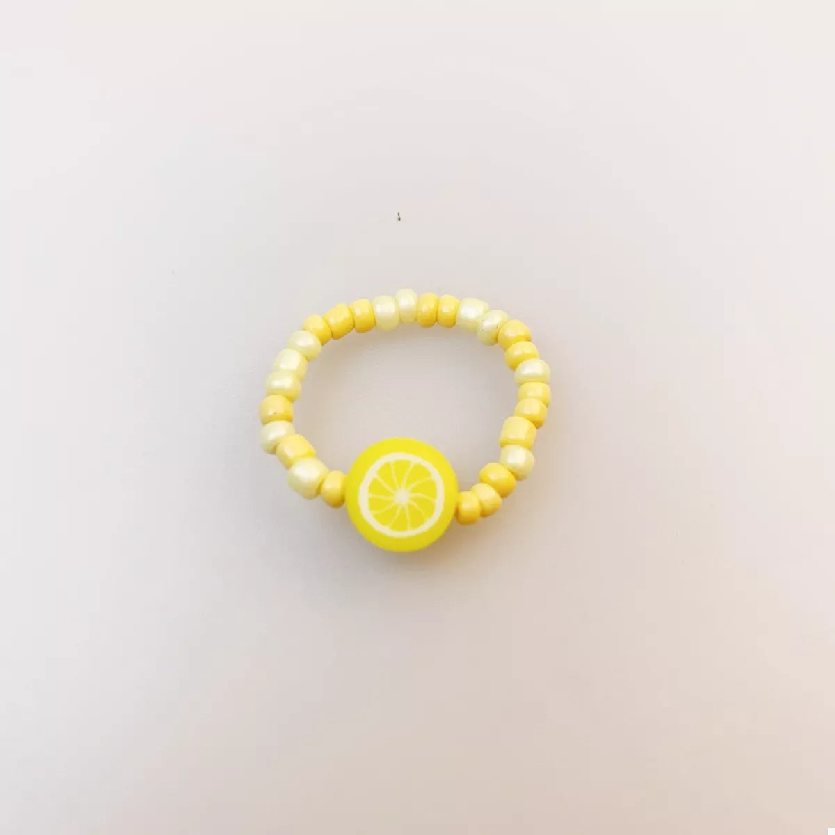 Colorful fruit charm beaded ring with vibrant beads and detailed fruit designs, stylish jewelry by Plush Fashion Hub.