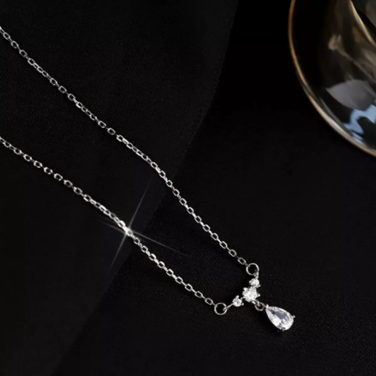 Sterling silver zircon teardrop necklace featuring a delicate pendant, showcasing elegance and craftsmanship.