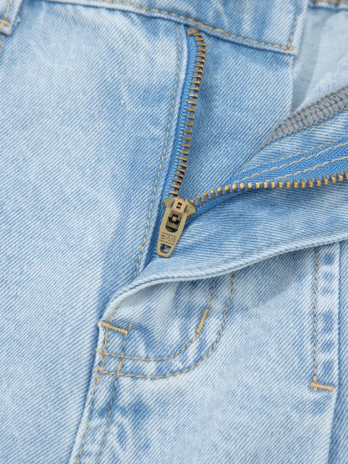 Stylish plush fashion hub studded wide leg jeans with frayed hem and side slits, showcasing a trendy denim look.