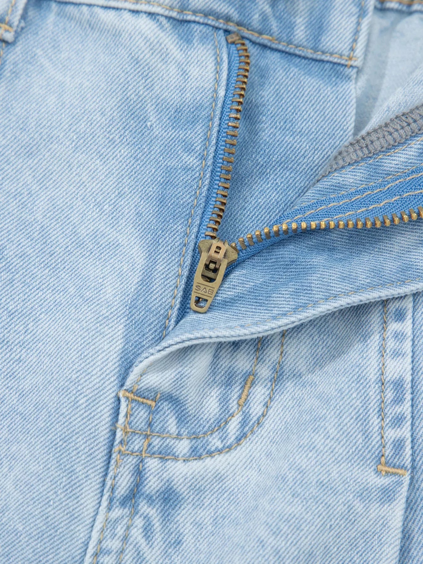 Trendsi studded wide-leg jeans with frayed hem and side slits, showcasing distressed denim and trendy design details.