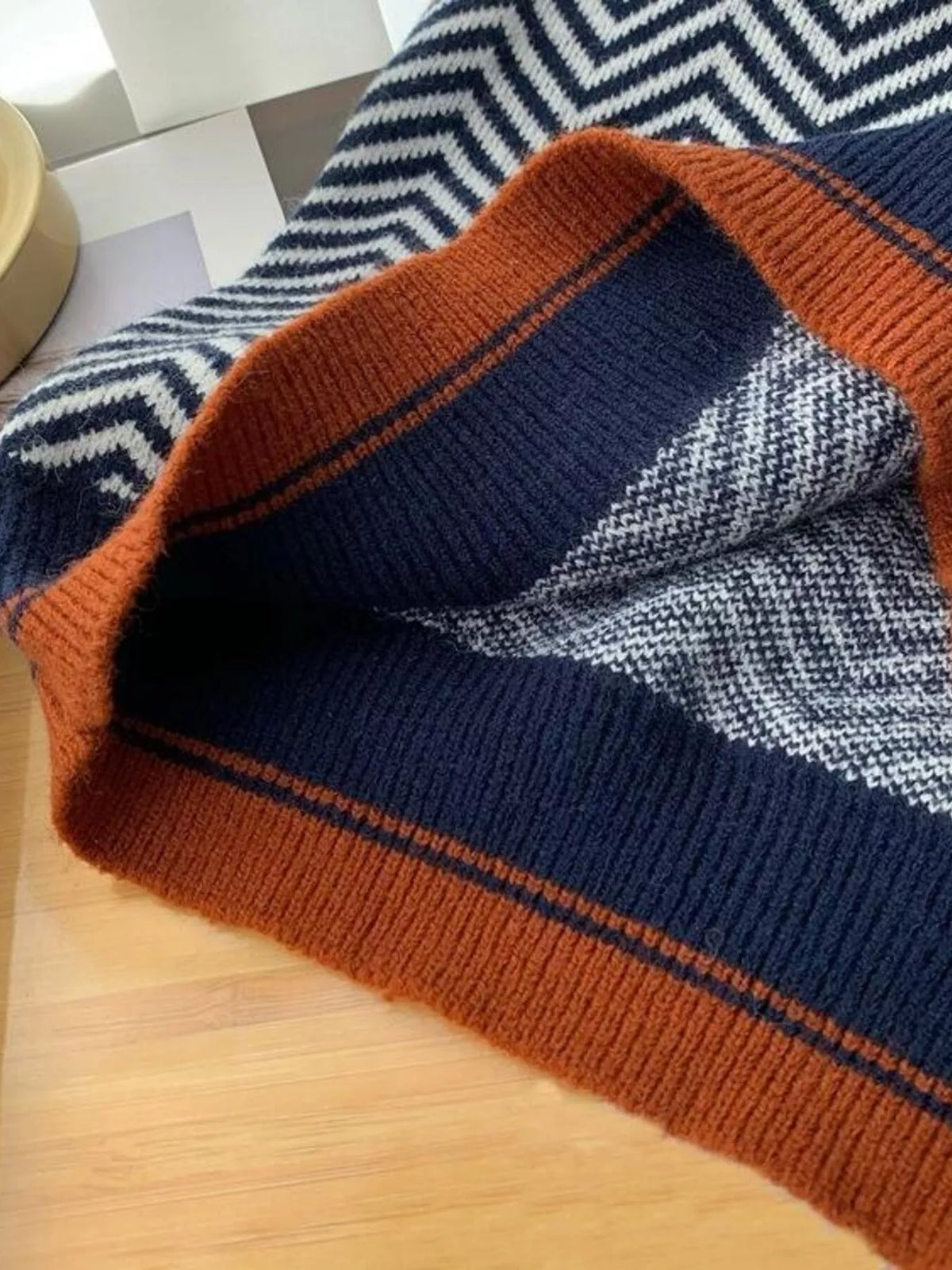 Chevron pattern V-neck knit sweater vest from Trendsi, showcasing a stylish, textured design in a close-up view.