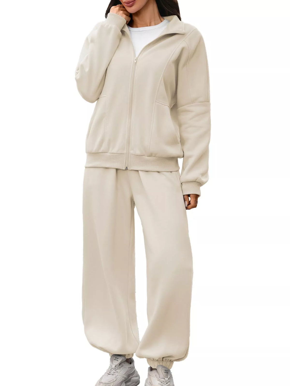 Women's zip-up long sleeve top and pants set by Trendsi, featuring a comfortable matching athleticwear ensemble.