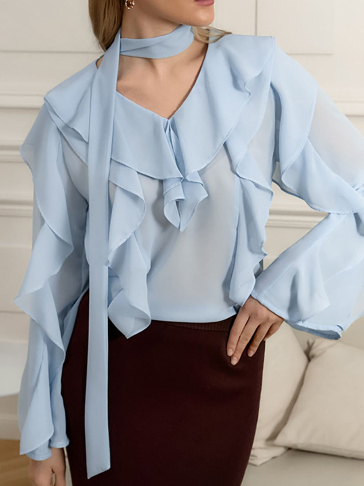 Elegant chiffon blouse with ruffle trim and tie neck by Plush Fashion Hub, featuring a flowy fabric and feminine design.