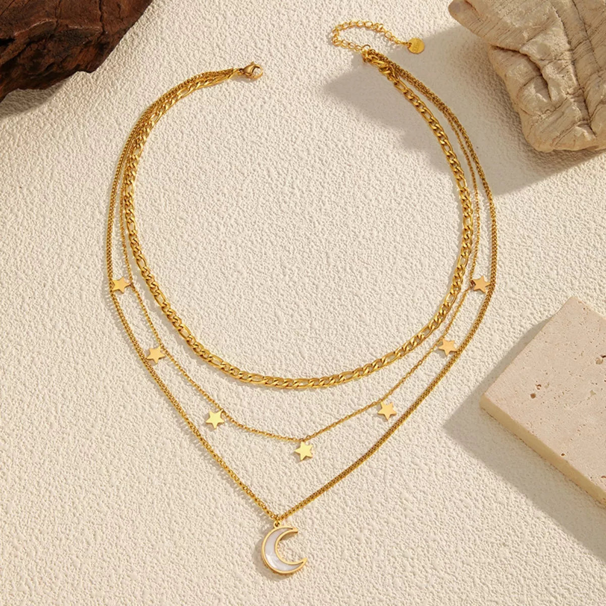 Three-layered moon necklace with 18K gold-plated finish, featuring delicate crescent moon charms on a fine chain.