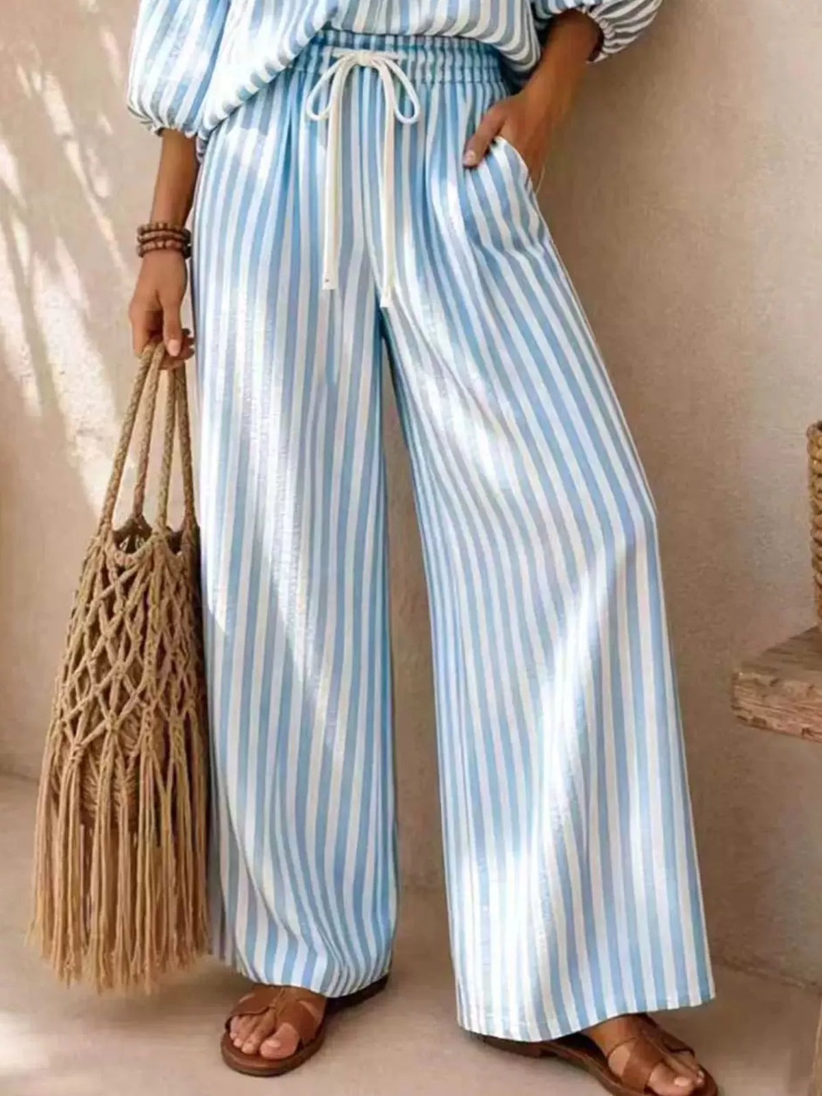 Plus size striped puff sleeve shirt and wide-leg drawstring pants set from Trendsi, featuring a coordinated matching outfit.
