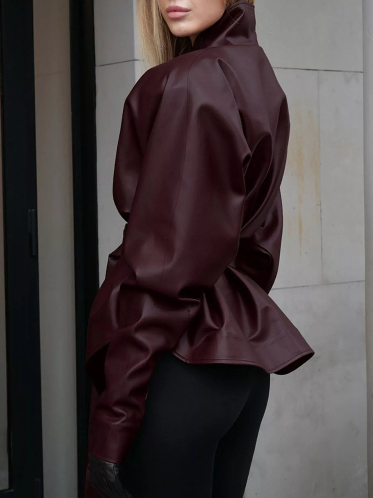 Women's faux leather jacket with stand collar and belt by Trendsi, featuring a stylish design and tailored fit.
