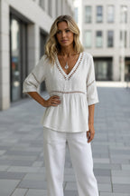 Women's V-neck cotton-linen top with hollow-out fringe details, casualwear by FitiqueFit, shown on a model.