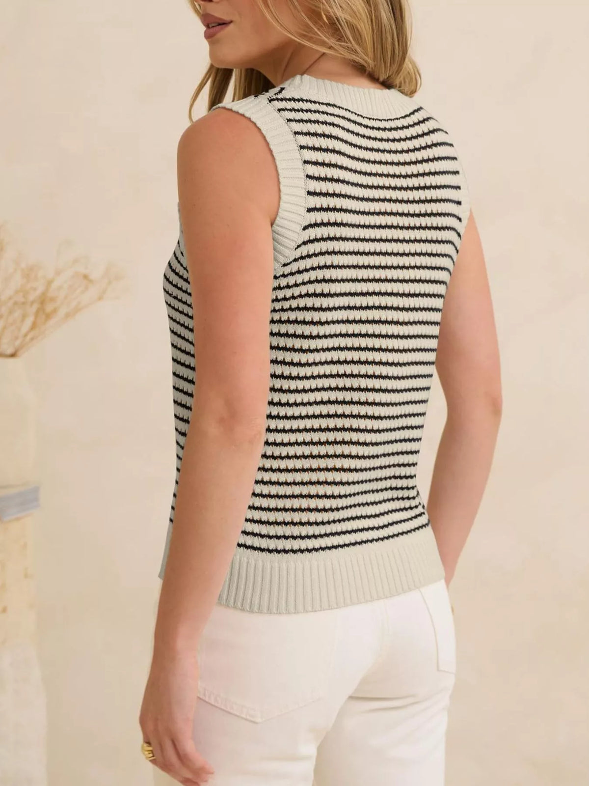 Striped knit sweater vest from Plush Fashion Hub showcasing a cozy, stylish design with colorful horizontal stripes.